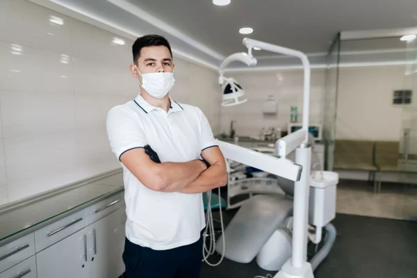 dentist-with-surgical-mask-posing-office